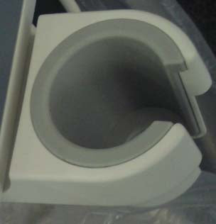 This appears to be a plastic mount or holder for an unknown item, possibly a cylindrical object like a cup holder or a part of a larger system.