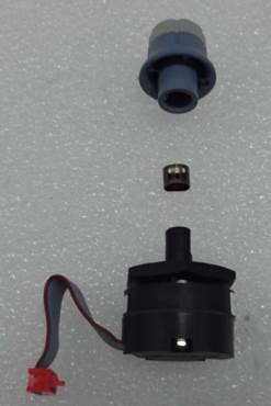 This appears to be a disassembled paddle wheel water flow sensor.