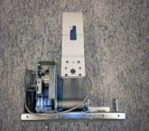This is an Aladdin Light Lift remote mount system, a motorized winch used to raise and lower heavy or hard-to-reach light fixtures like chandeliers for easy maintenance