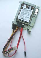 This is a 2.5-inch hard disk drive (HDD) mounted in a 3.5-inch drive bay adapter bracket, connected via SATA data and power cables